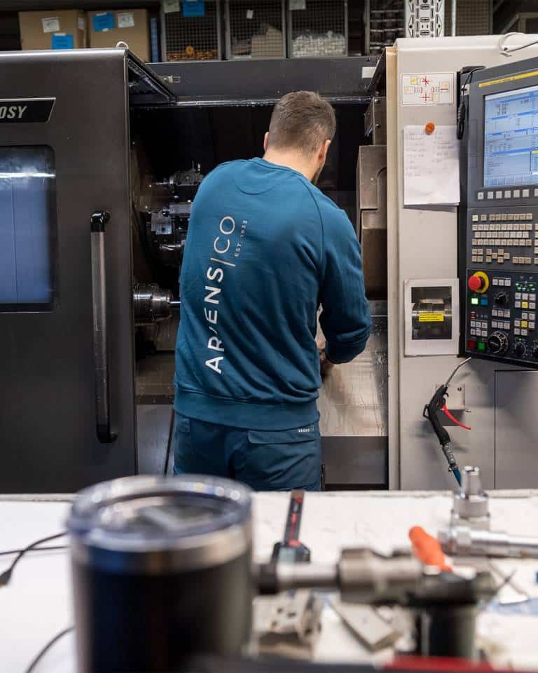 Factory worker of AriensCo EMEAA wearing their new turquise work wear inside their factory in Bühlertann, Germany