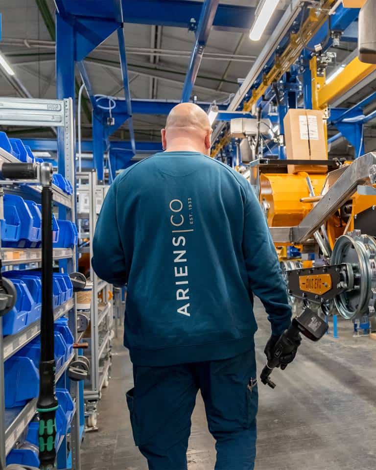 Factory worker of AriensCo EMEAA wearing their new turquise work wear inside their factory in Bühlertann, Germany